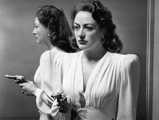 Joan Crawford in film Mildred Pierce(1945), costume by Adrian