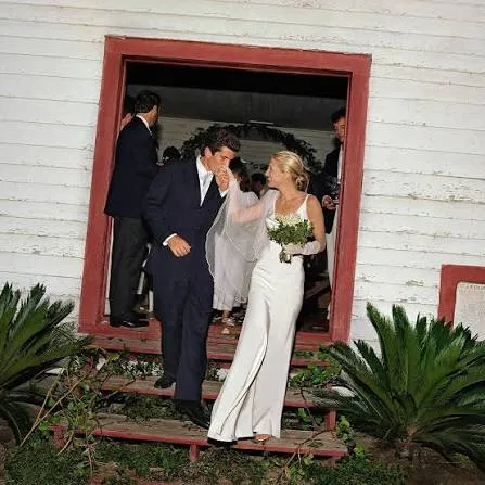 John F. Kennedy Jr. kissing the hand of Carolyn Bessette in her Narciso Rodriguez wedding dress, Cumberland Island, 21 September 1996