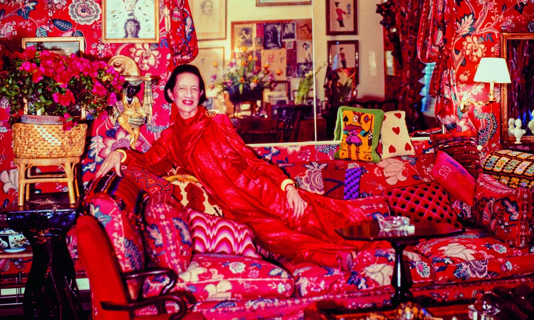 Diana Vreeland in red ensemble at her home full of colors