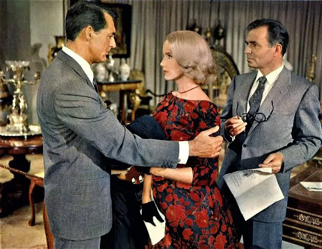 Eva Marie Saint in a black rose dress between James Mason and Cary Grant at the auction in North by Northwest (film, 1959)