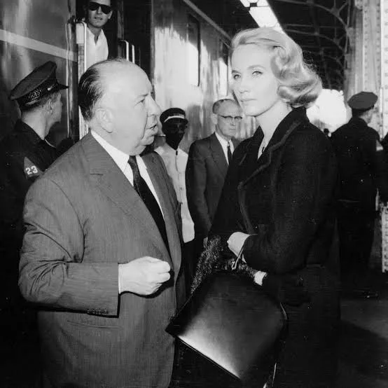 Alfred Hitchcock and Eva Marie Saint in the black rose dress on the set of North by Northwest (film, 1959)