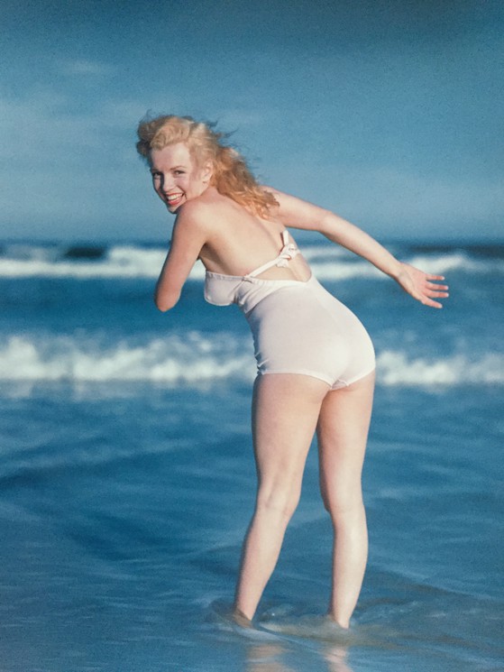 Elegant style icon wardrobe essentials: Marilyn Monroe in swimwear, a one piece pink bathing swimming suit