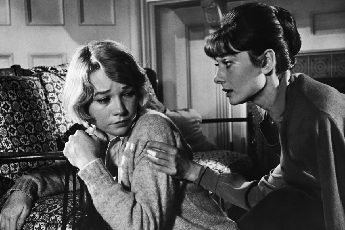 Elegant style icon wardrobe essentials: Audrey Hepburn in cardigan sweater,  in film The Children's Hour, 1961