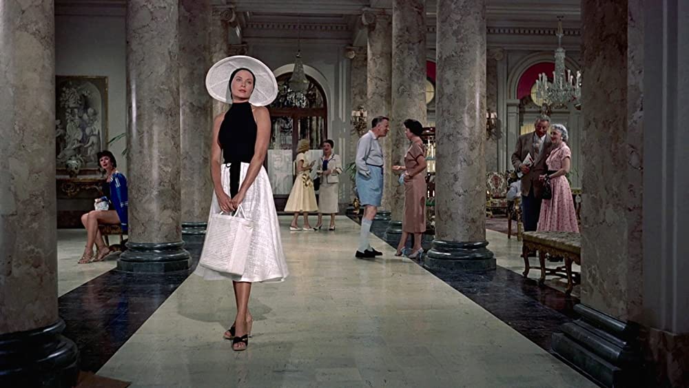 Elegant style icon wardrobe essentials: Grace Kelly in swimwear, a halter neck one piece swimming suit, in film To Catch a Thief(1956)