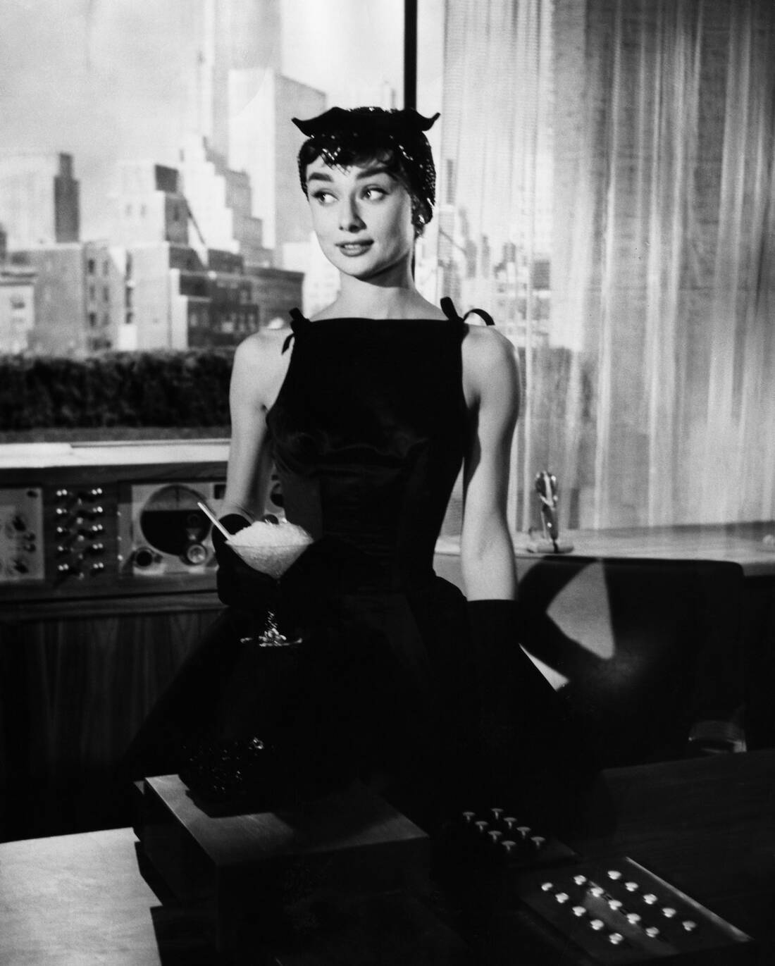 Elegant style icon wardrobe essentials: Audrey Hepburn in little black dress in film Sabrina(1954)