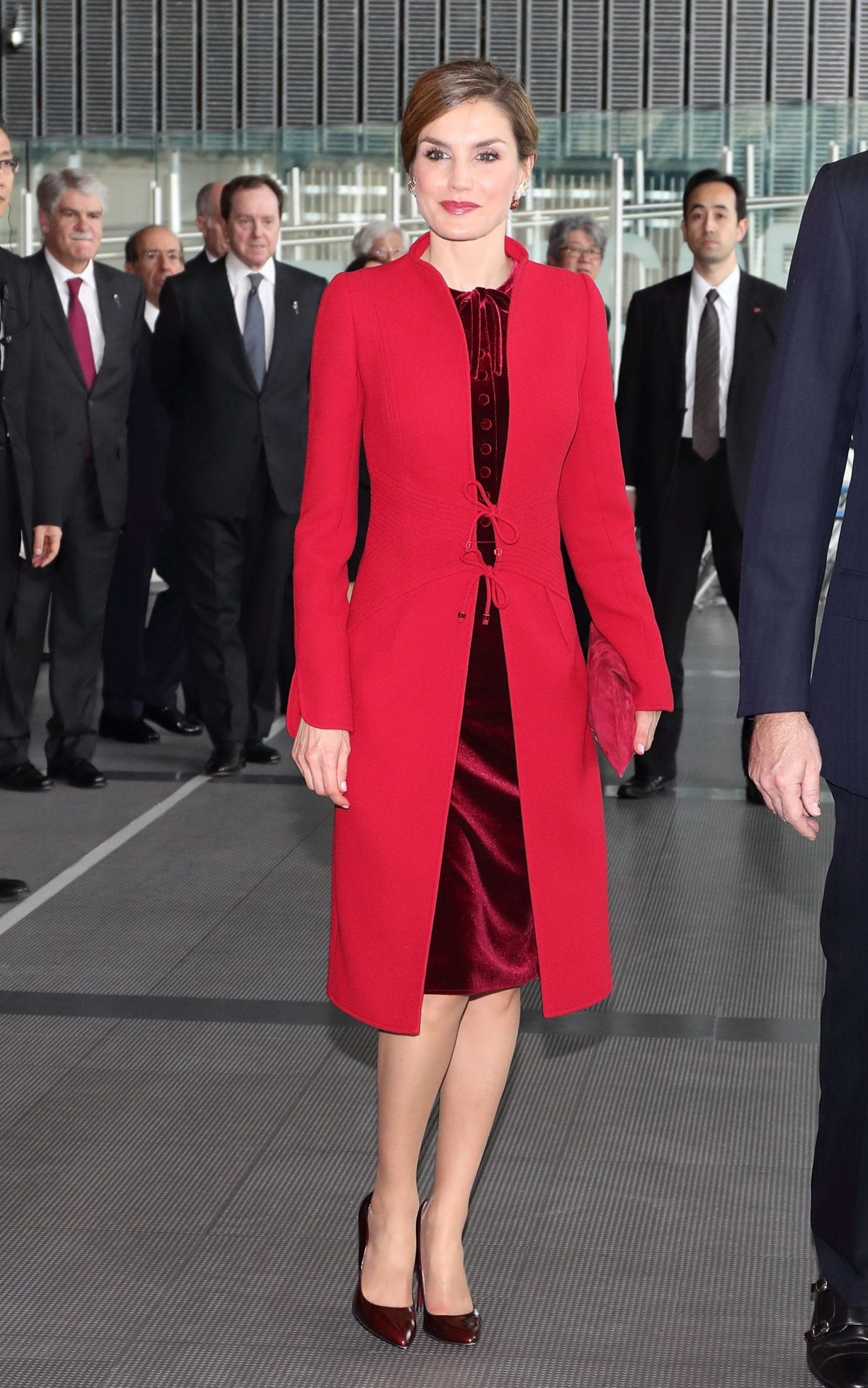 Queen Letizia red coat of standup collar with tie-front closure by Felipe Varela