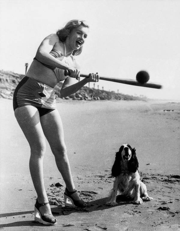 Elegant style icon wardrobe essentials: Marilyn Monroe in swimwear, a two piece halter neck bikini