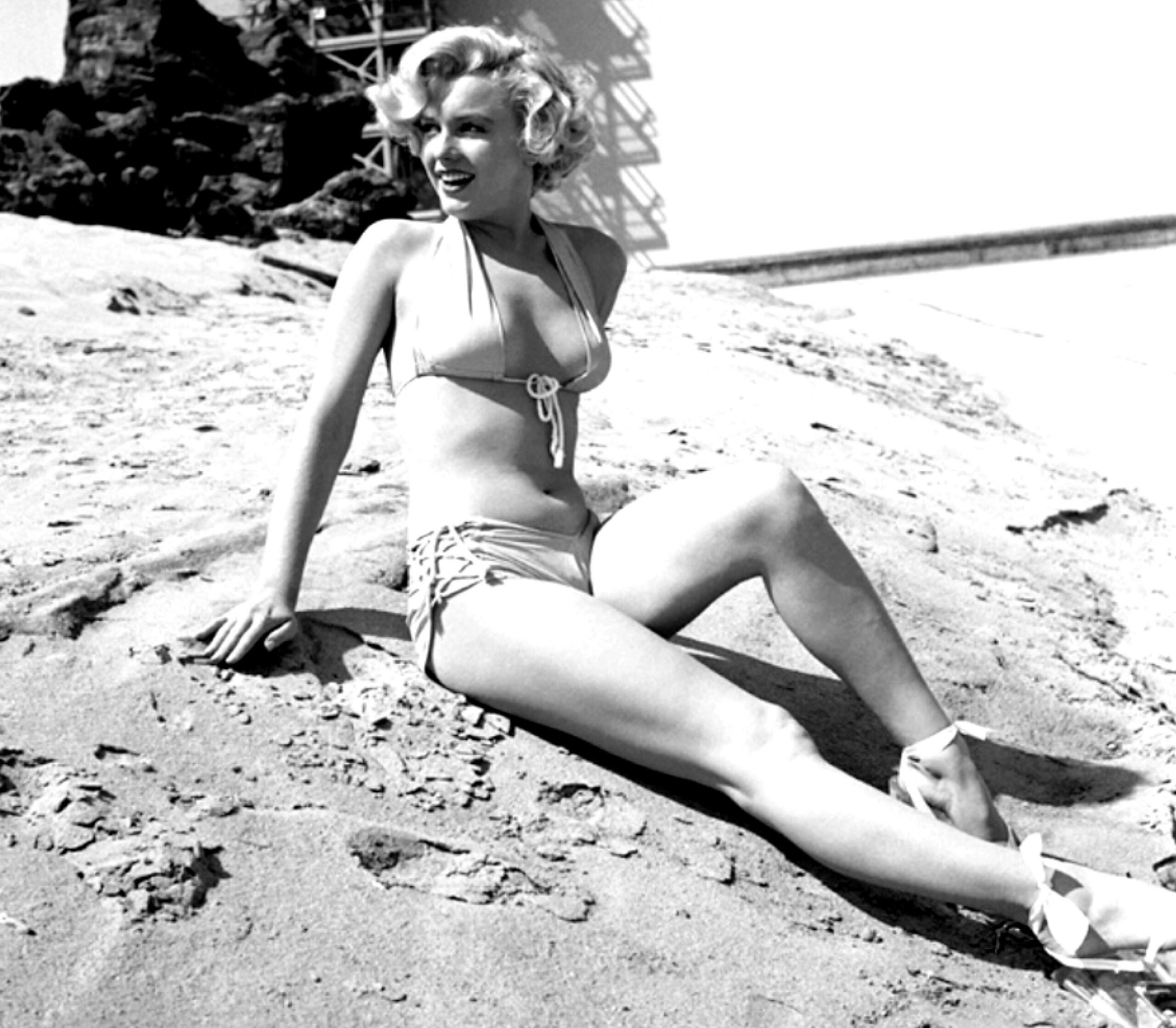 Elegant style icon wardrobe essentials: Marilyn Monroe in swimwear, a two piece halter neck bikini