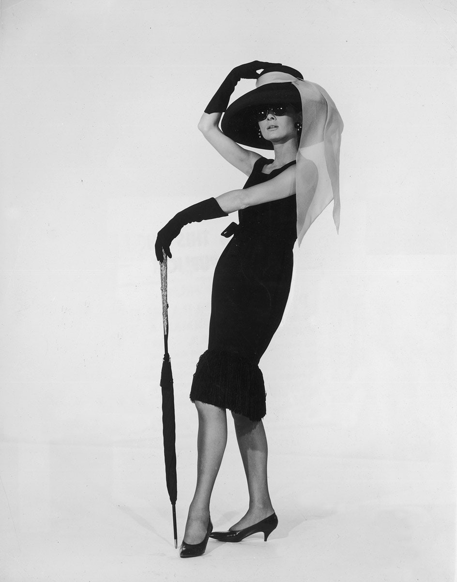 Elegant style icon wardrobe essentials: Audrey Hepburn in little black dress designed by Hubert de Givenchy, in film Breakfast at Tiffany's(1961)