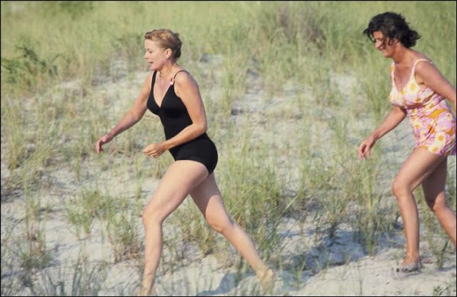 Elegant style icon wardrobe essentials: Grace Kelly in swimwear, a one piece black swimming suit