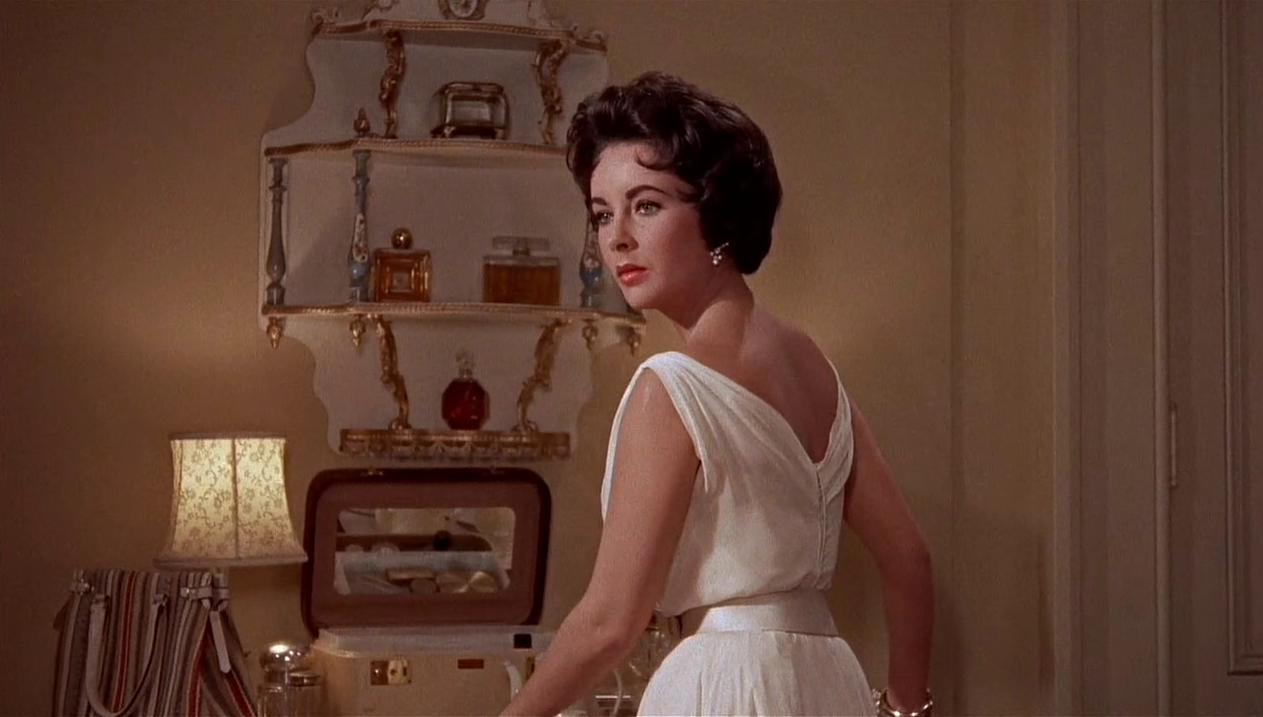 Elizabeth Taylor in film Cat on a Tin Roof( 1958), wearing a white chiffon dress designed by Helen Rose