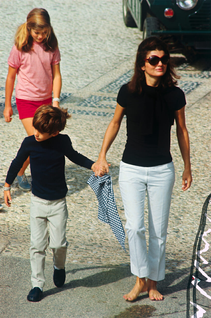Elegant style icon wardrobe essentials: Jackie Kennedy Onassis in capri pants, with her son John Kennedy Jr., Capri, Italy