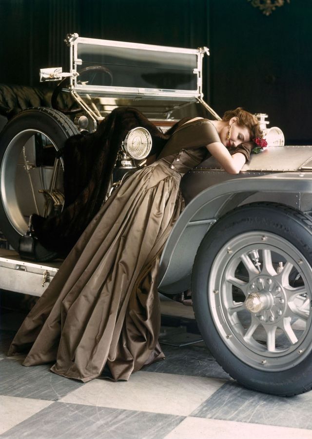 Wenda Parkinson in a Molyneux satin evening dress, posting with a 1907 Silver Ghost Rolls-Royce, photo by Norman Parkinson, 1950