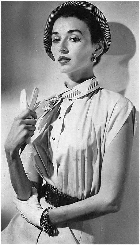 Dorian Leigh in white sleeveless with high wing collar blouse by Adelaar, photo by Clifford Coffin