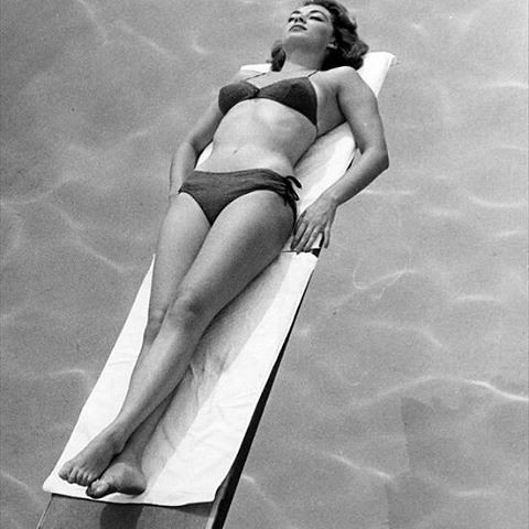Elegant style icon wardrobe essentials: Ava Gardner in swimwear, a two piece bikini in solid color