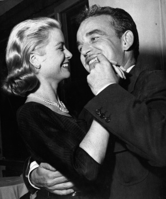 Elegant style icon wardrobe essentials: Grace Kelly in black dress with Prince Rainier of Monaco, 1955