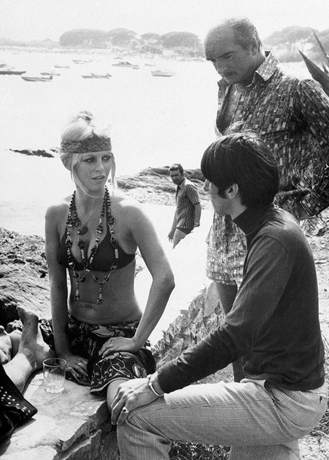 Elegant style icon wardrobe essentials: Brigitte Bardot in swimwear, a two piece bikini in black, August 1968