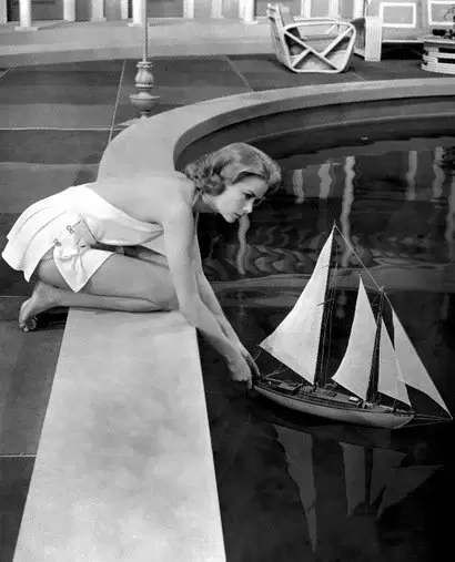 Elegant style icon wardrobe essentials: Grace Kelly in swimwear, a halter neck one piece swimming suit, in film High Society