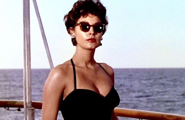 Elegant style icon wardrobe essentials: Ava Gardner in swimwear, a one piece swimsuit in black, in film The Barefoot Contessa(1954)