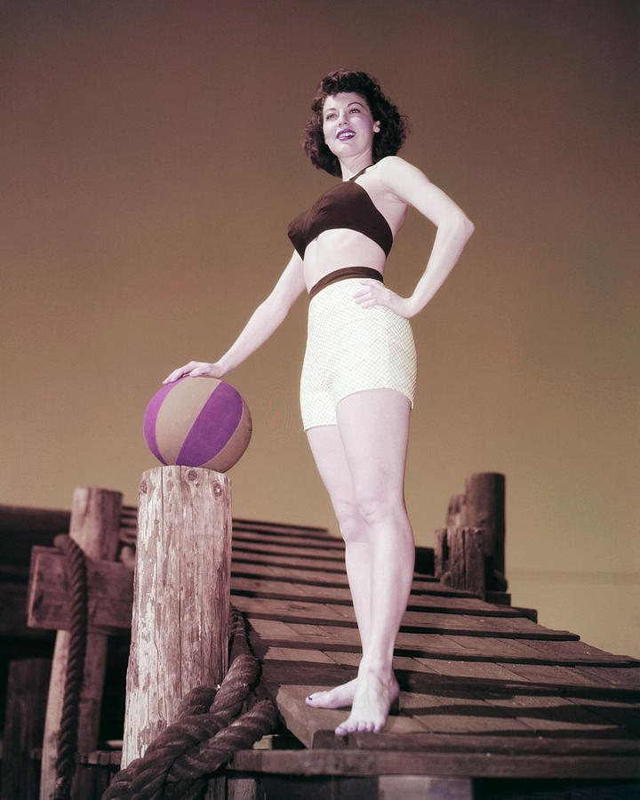 Elegant style icon wardrobe essentials: Ava Gardner in swimwear, a two piece bikini in solid color