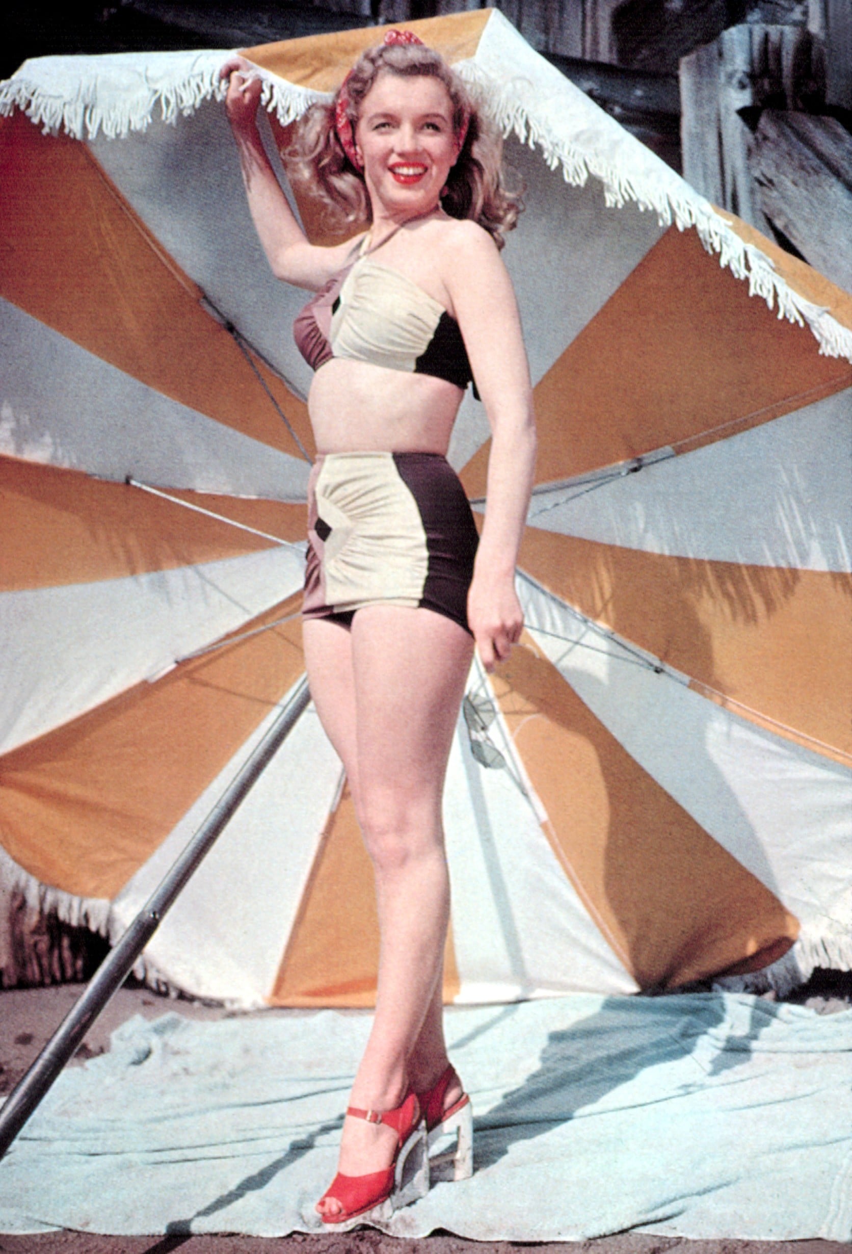 Elegant style icon wardrobe essentials: Marilyn Monroe in swimwear, a two piece halter neck bikini