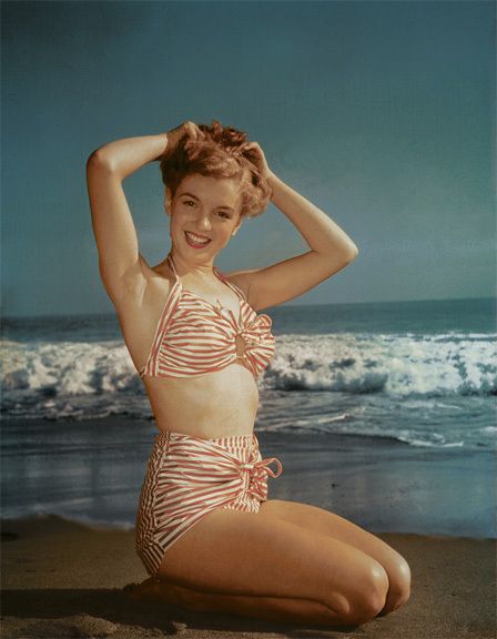 Elegant style icon wardrobe essentials: Marilyn Monroe in swimwear, a two piece halter neck bikini