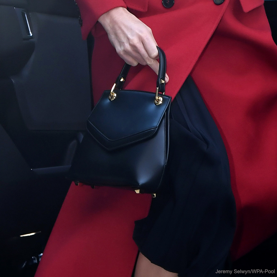 Kate Middleton Duchess of Cambridge custom made/bespoke Alexander McQueen red double breast full length coat with peak lapel for Hold Still photography project at Waterloo Station in London 