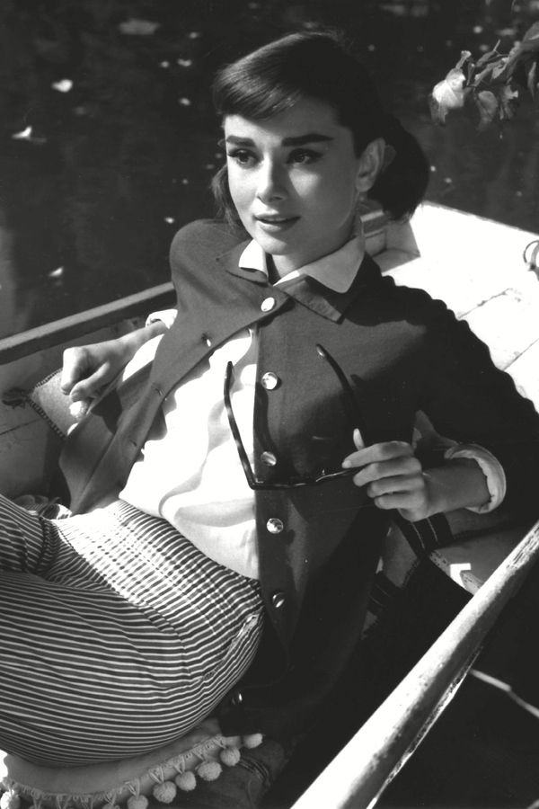 Elegant style icon wardrobe essentials: Audrey Hepburn in cardigan sweater in film Love in the Afternoon