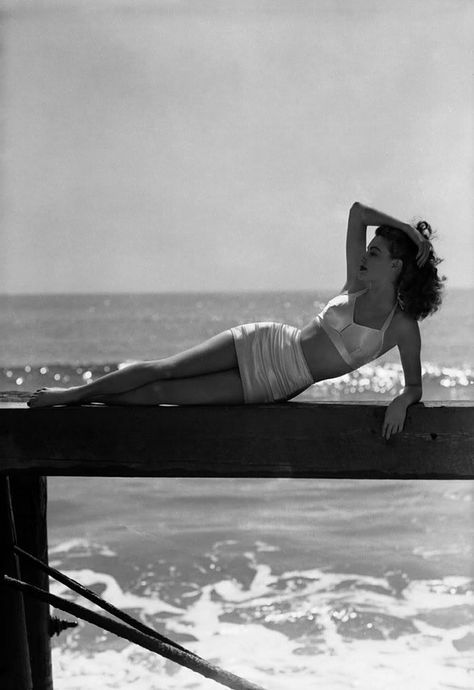 Elegant style icon wardrobe essentials: Ava Gardner in swimwear, a two piece bikini in solid color