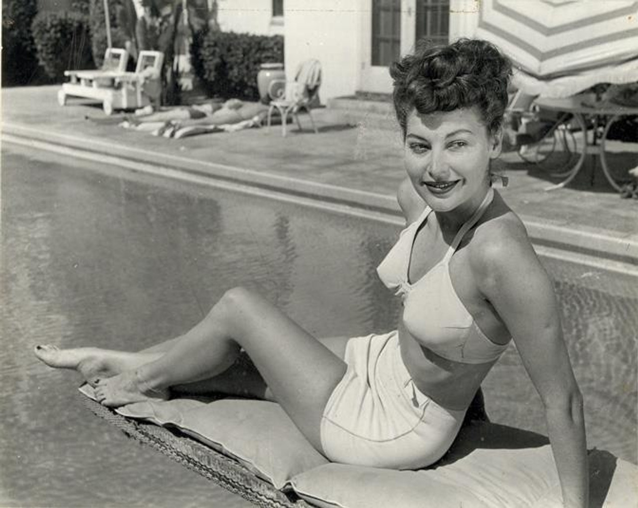 Elegant style icon wardrobe essentials: Ava Gardner in swimwear, a two piece bikini in solid color