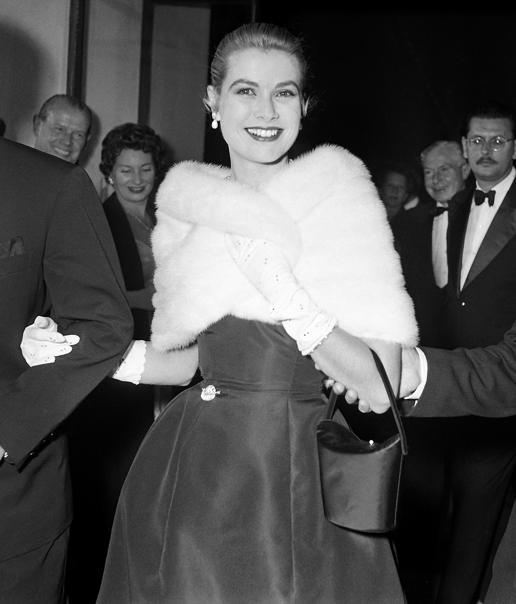 Elegant style icon wardrobe essentials: Grace Kelly in black dress with Jean-Pierre Aumont. 1955