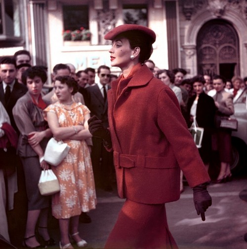 Dorian Leigh (April 23, 1917 – July 7, 2008), the first American supermodel, in red coat, 1954, photo by Georges Dambier, Normandy, France