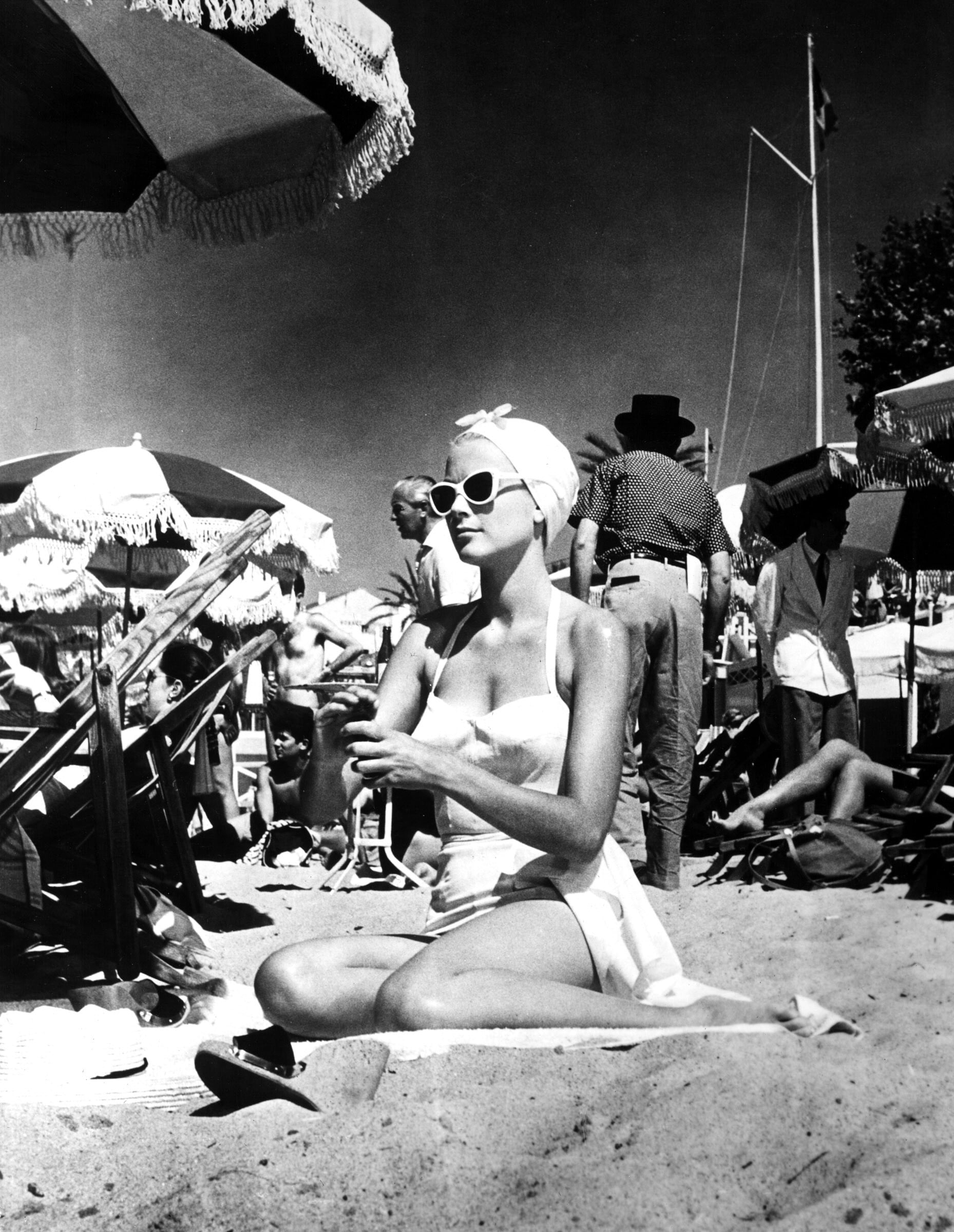 Elegant style icon wardrobe essentials: Grace Kelly in swimwear, a halter neck one piece swimming suit, in film To Catch a Thief(1956)