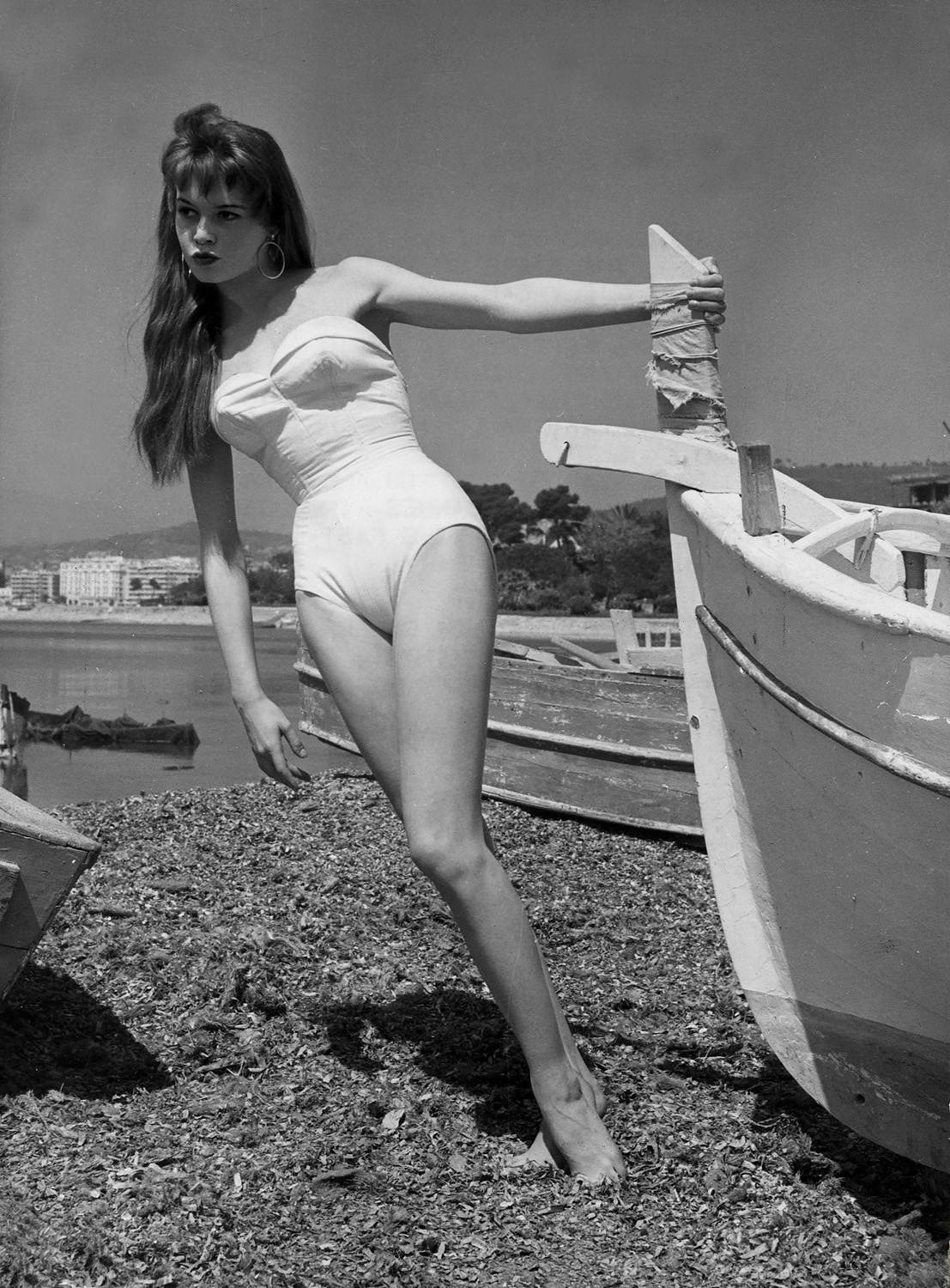 Elegant style icon wardrobe essentials: Brigitte Bardot in swimwear, a one piece strapless swimsuit
