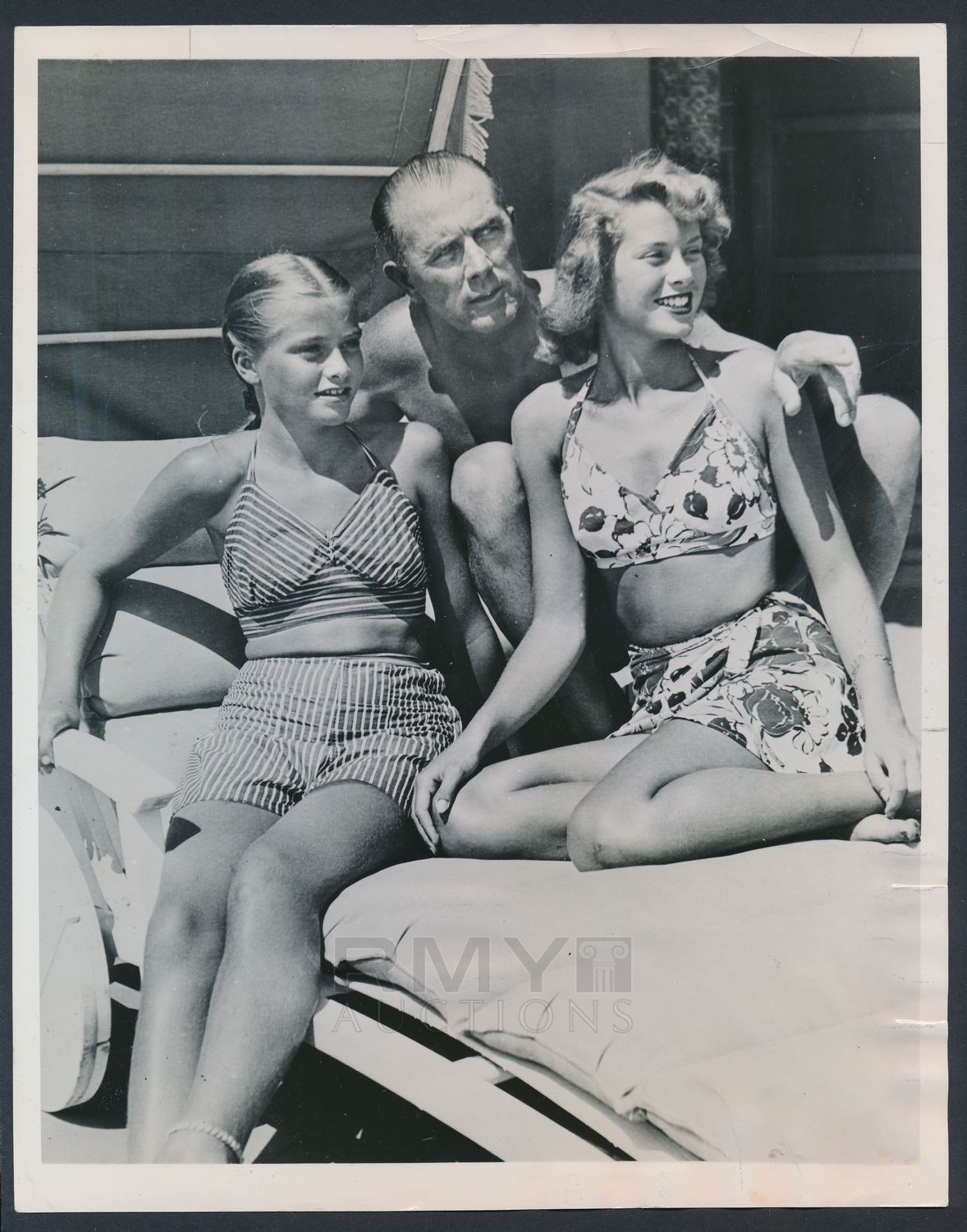 Elegant style icon wardrobe essentials: Grace Kelly in swimwear, a halter neck printed bikini