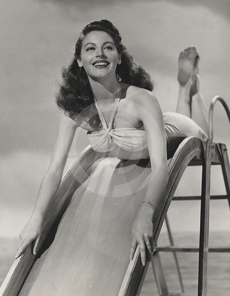 Elegant style icon wardrobe essentials: Ava Gardner in swimwear, a two piece bikini in solid color