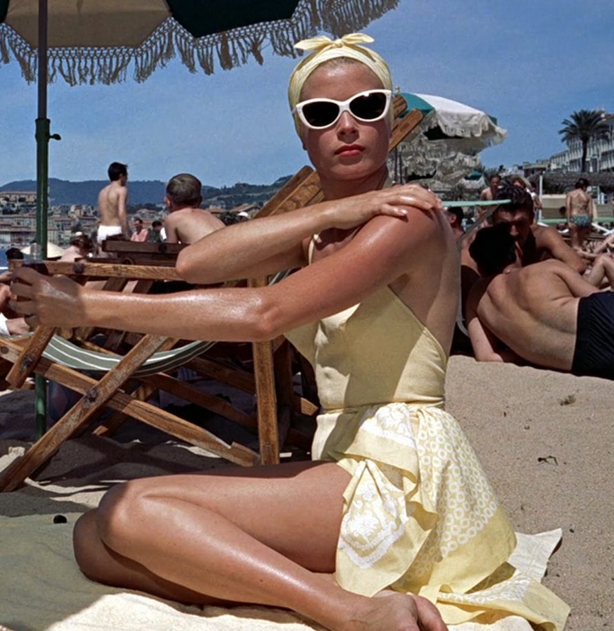 Elegant style icon wardrobe essentials: Grace Kelly in swimwear, a halter neck one piece swimming suit, in film To Catch a Thief(1956)