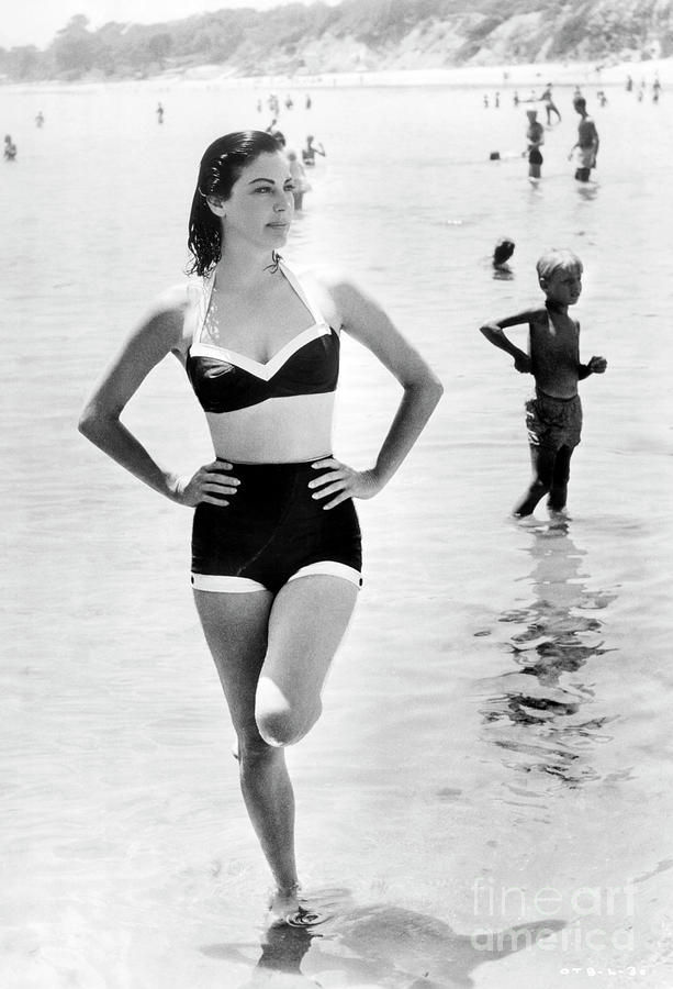 Elegant style icon wardrobe essentials: Ava Gardner in swimwear, a two piece bikini in solid color