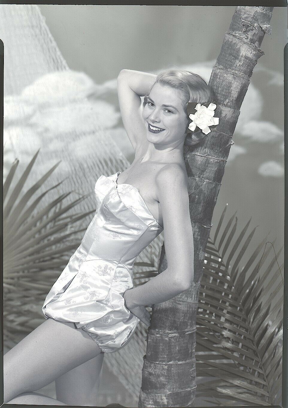 Elegant style icon wardrobe essentials: Grace Kelly in swimwear, a satin one piece strapless swimming suit