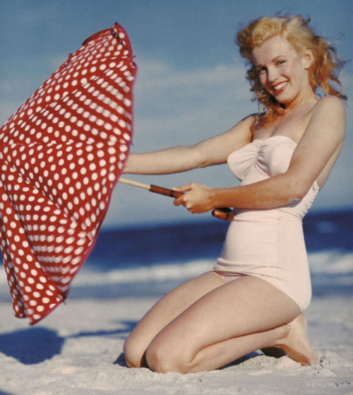 Elegant style icon wardrobe essentials: Marilyn Monroe in swimwear, a one piece pink bathing swimming suit
