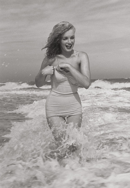 Elegant style icon wardrobe essentials: Marilyn Monroe in swimwear, a one piece pink bathing swimming suit
