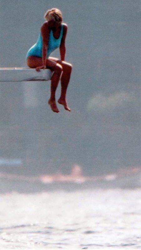 Elegant style icon wardrobe essentials: Princess Diana in swimwear, a one piece pale blue swimsuit