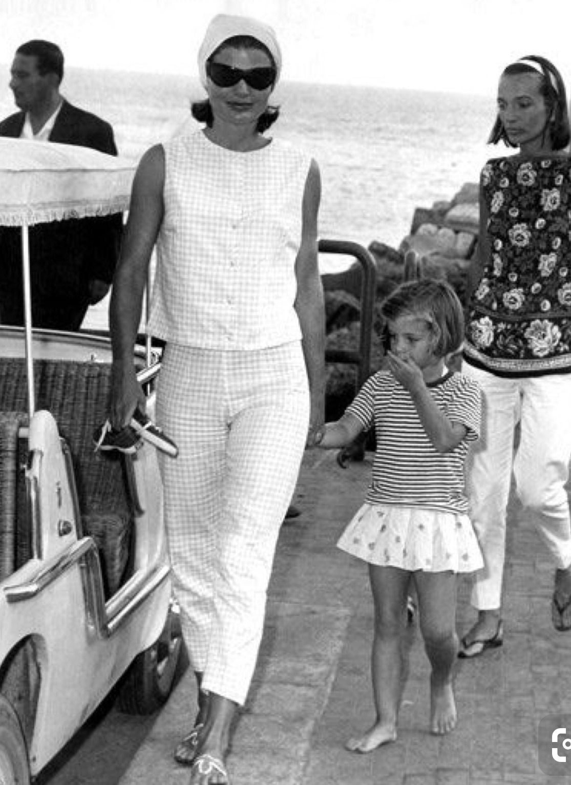 Elegant style icon wardrobe essentials: Jackie Kennedy Onassis in capri pants, with her daughter Caroline Kennedy, Capri, Italy