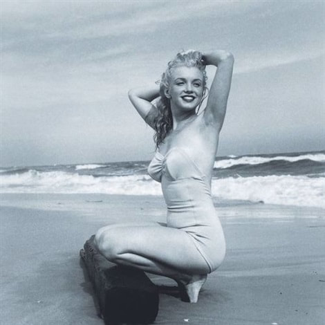 Elegant style icon wardrobe essentials: Marilyn Monroe in swimwear, a one piece pink bathing swimming suit