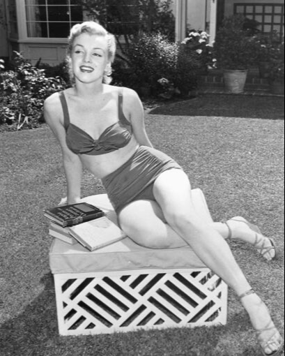 Elegant style icon wardrobe essentials: Marilyn Monroe in swimwear, a two piece bikini