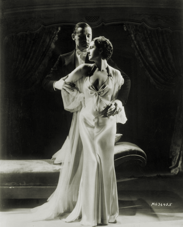 Norma Shearer and Herbert Marshall in publicity photo for film Riptide(1934)