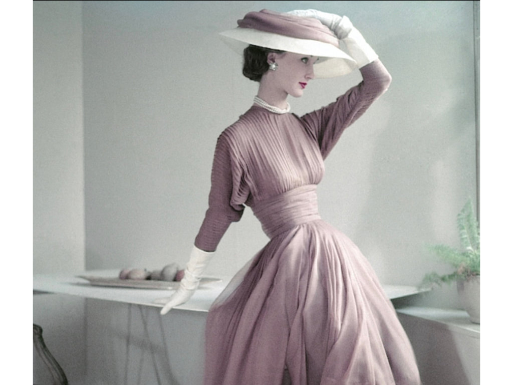 Evelyn Tripp wearing fascia dress in fawn silk muslin, white gloves, and matching hat Vogue March 1952,  © Frances McLaughlin-Gill