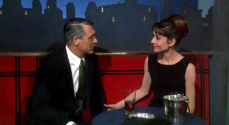 Elegant style icon wardrobe essentials: Audrey Hepburn in little black dress designed by Hubert de Givenchy, in film Charade(1963)