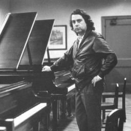 French composer Philippe Sarde standing in front of a piano as a young man