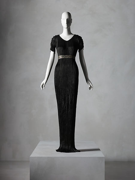 Red pleated silk column evening dress with obi, designed by Claire McCardell for Townley Frocks, 1950, Gift of Irving Drought Harris, in memory of Claire McCardell Harris to the Met, New York, 1958. Copyright Metropolitan Museum of Art